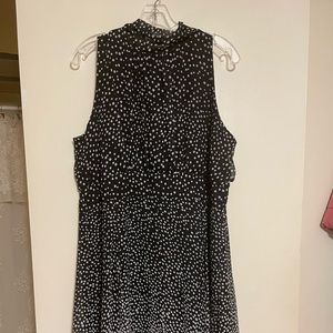 Simple black and white polka dot dress with a large accent bow in the back.